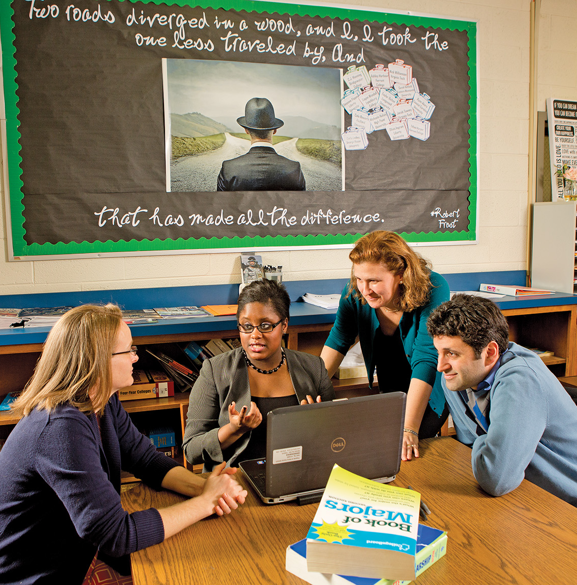 Erica Elder (center) confers with her College Advising Corps (CAC) colleagues (from left) Joy Pugh, Nicole Hurd and Kevin Anselmo. Hurd, CAC’s founder and CEO, says: “The job of an adviser is to be a messenger of hope,” to help low-income, first- generation students “fulfill their potential through education.”