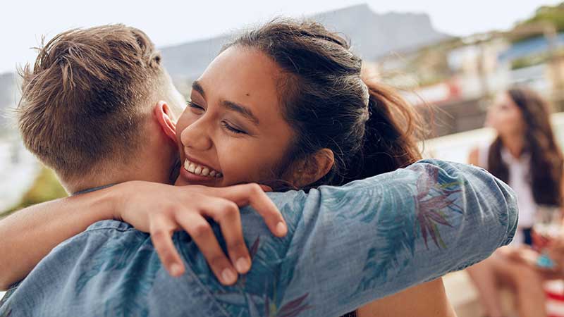 Students embrace at reunion.