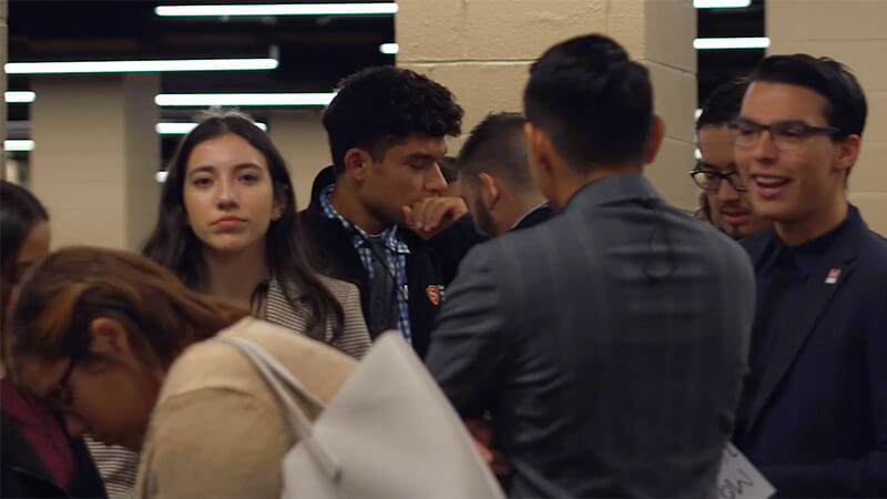 a bunch of students standing in line, candid still from video